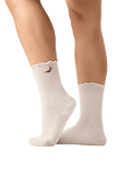 White socks with a small design on the leg against a transparent background