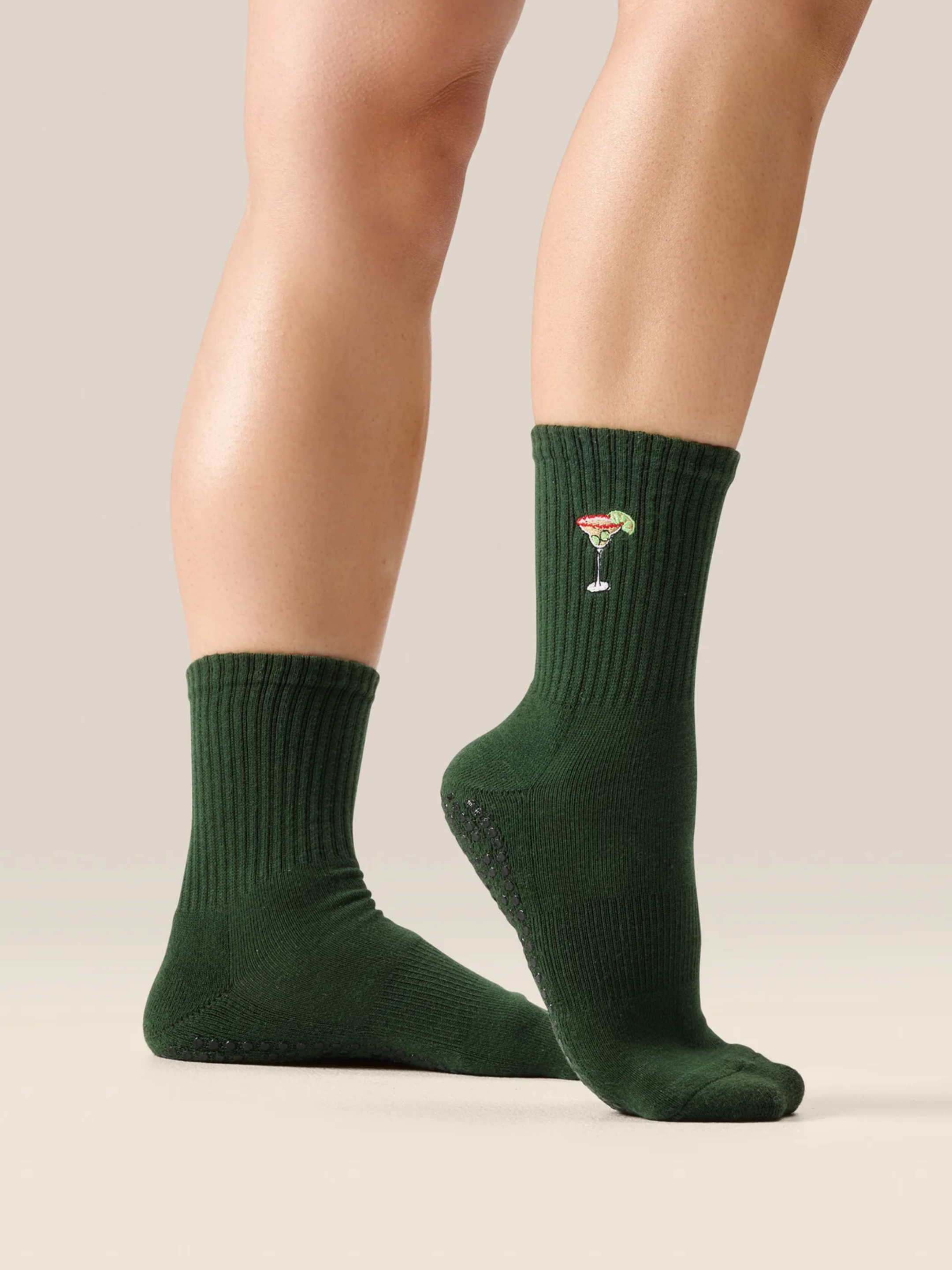 cute Pilates grip socks UK. Green socks with a design on a neutral background