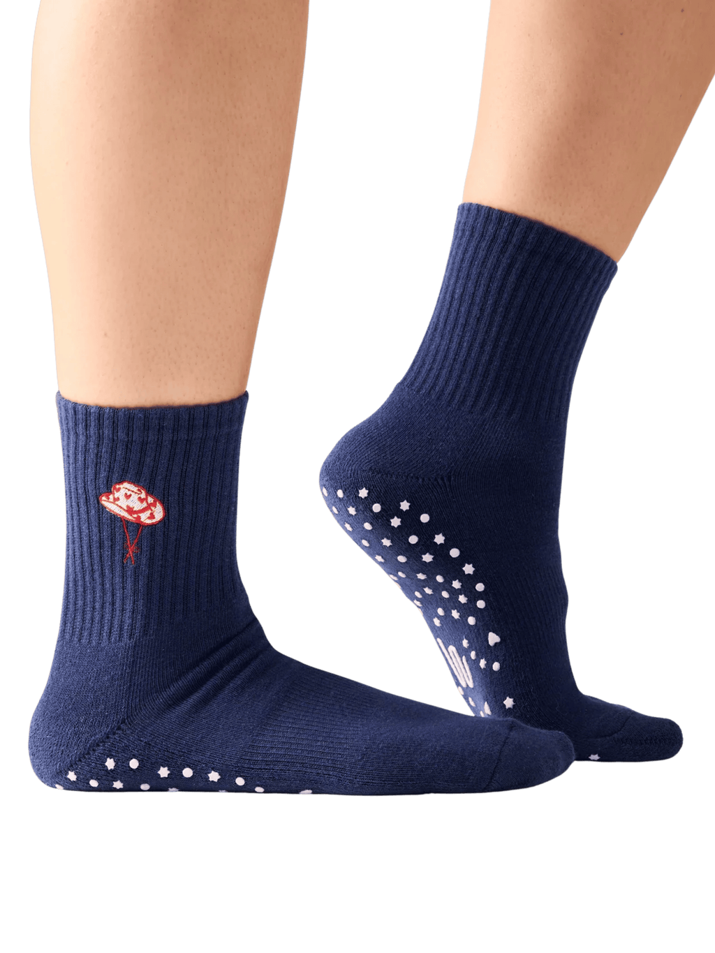 Navy blue socks with a floral design and white grip dots on a transparent background