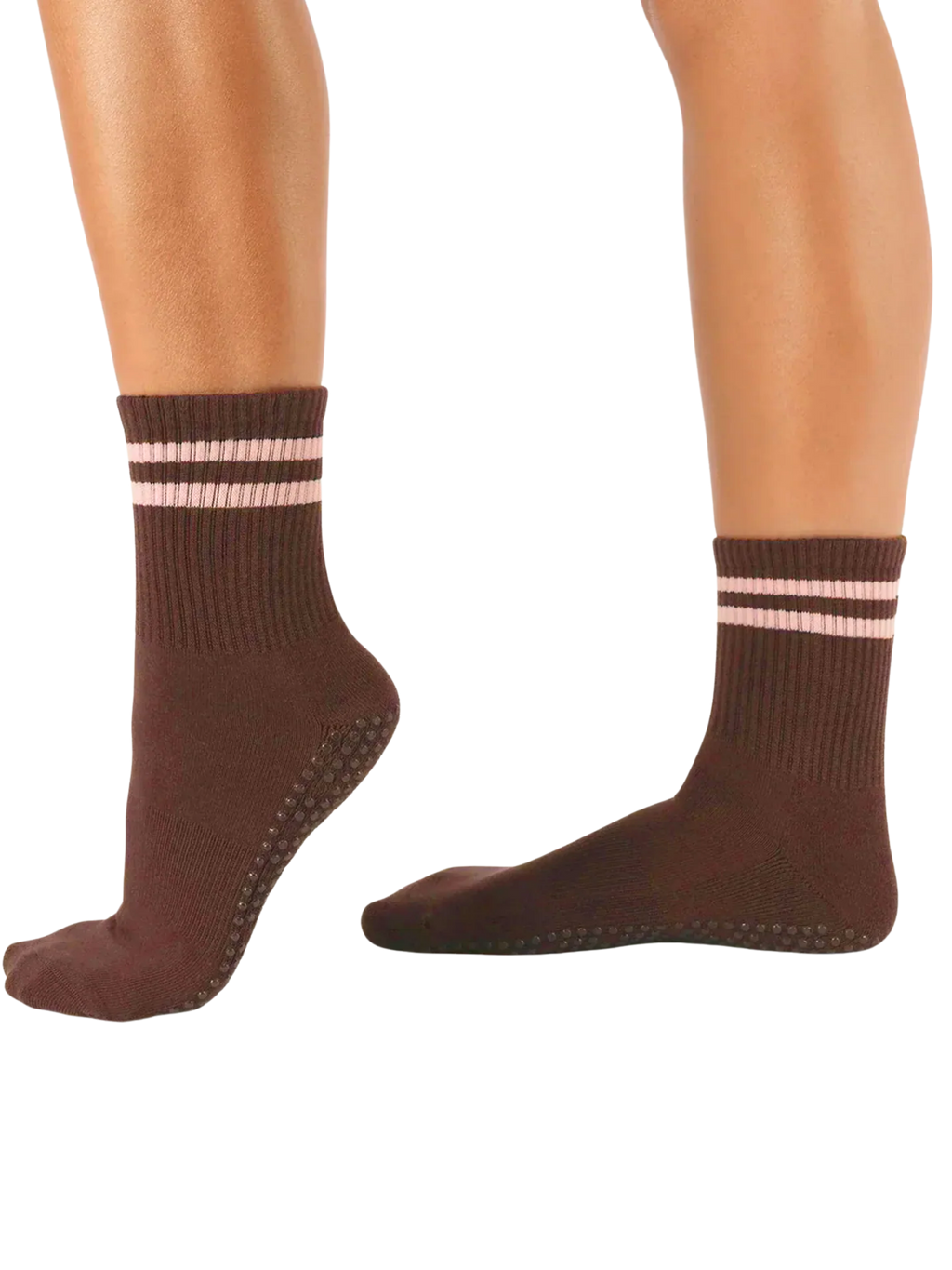 Brown socks with pink stripes worn by a person on a white background