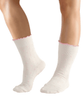 White socks with pink trim worn by a person on a transparent background