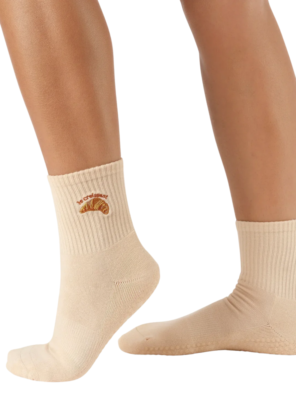 Beige socks with a croissant design on a white background