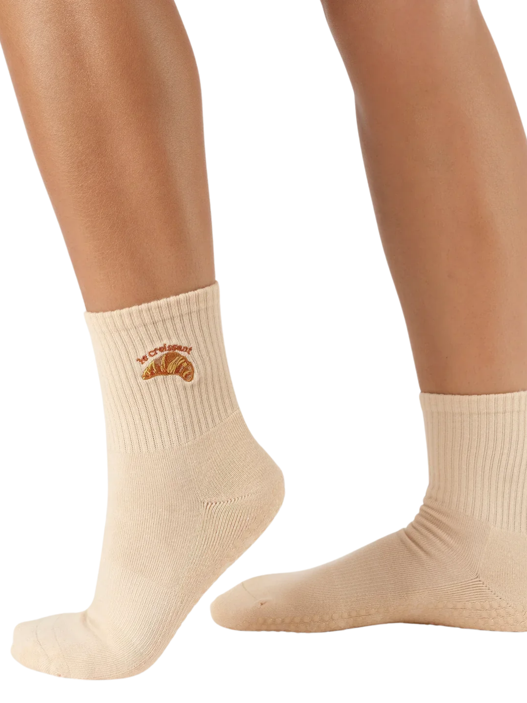 Beige socks with a croissant design on a white background