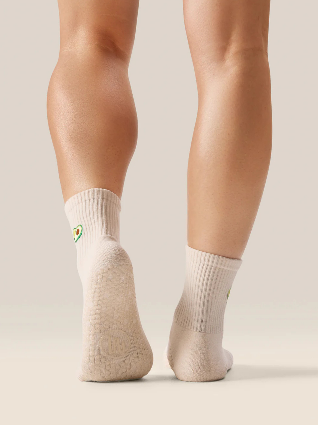 Beige socks worn by a person on a light background