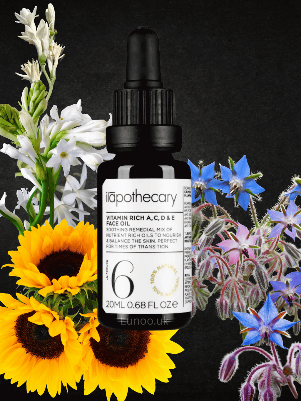 Bottle of 'ilapothecary' vitamin-rich serum surrounded by flowers on a black background