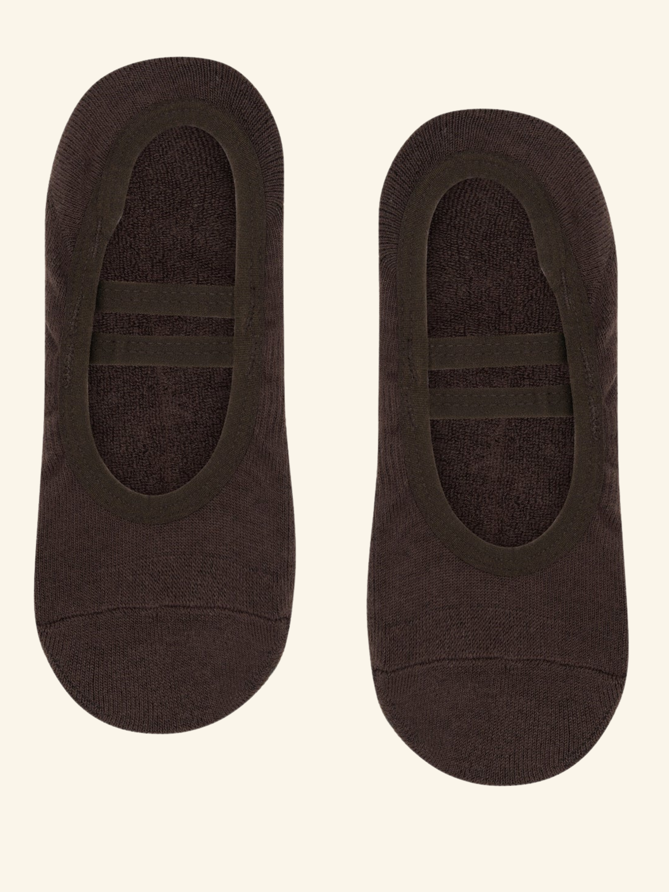 Pair of brown no-show socks on a beige background