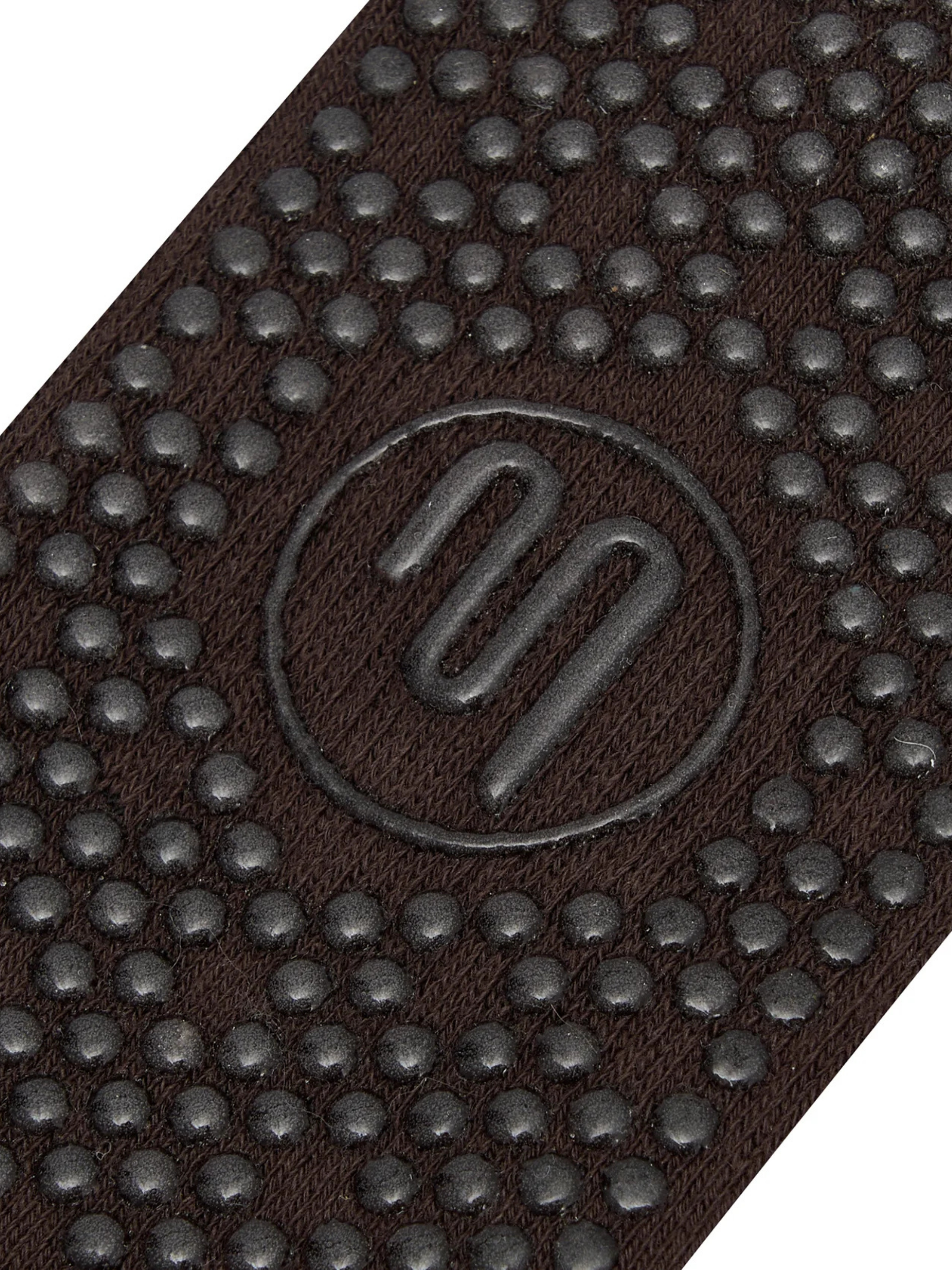 Close-up of a brown textured mat with a logo in the center.