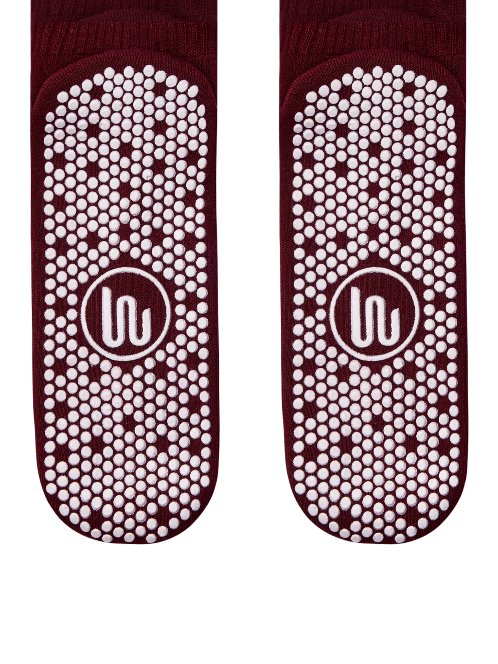 Pair of maroon socks with white textured sole pattern on a white background