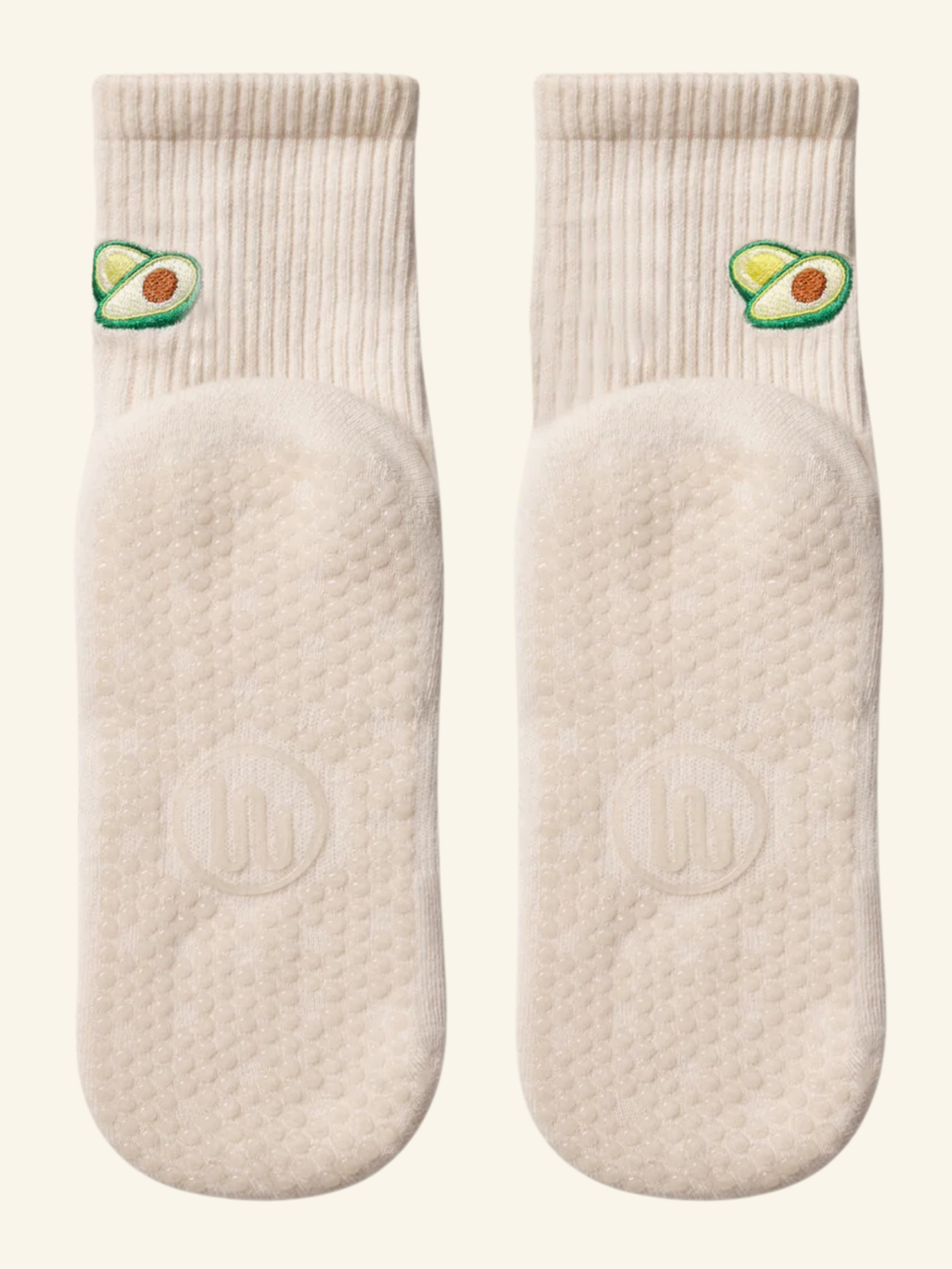Pair of white socks with avocado design on a white background