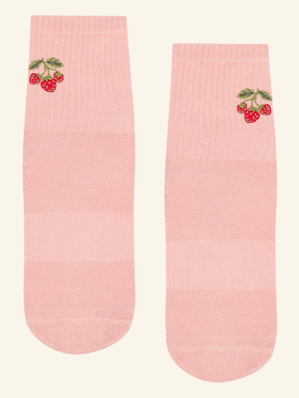 Pink socks with cherry design on a beige background