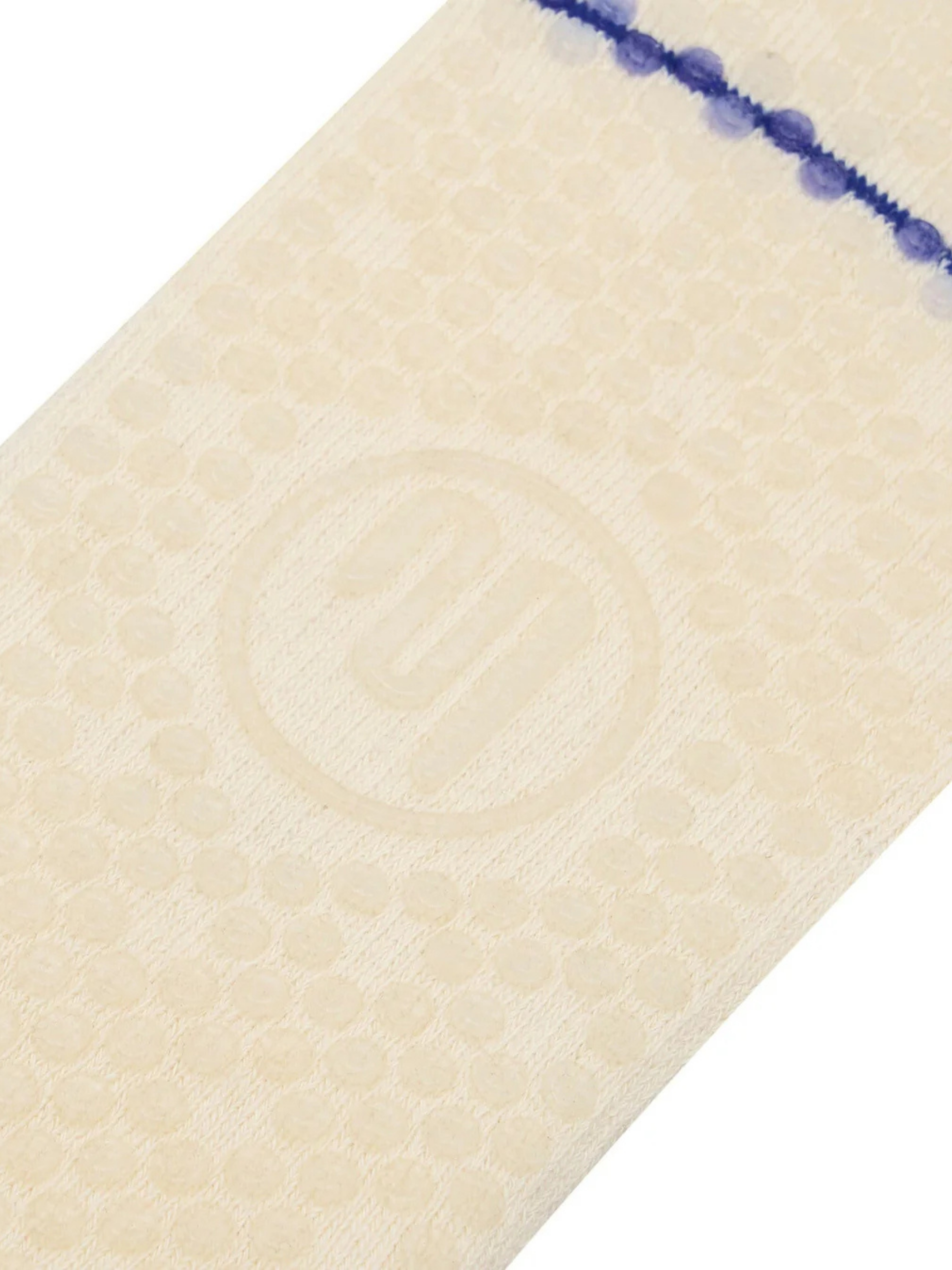 Close-up of a textured beige fabric with a blue line on a white background