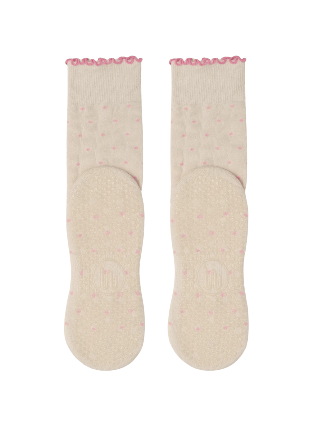 Pair of light pink socks with a subtle pattern on a green background
