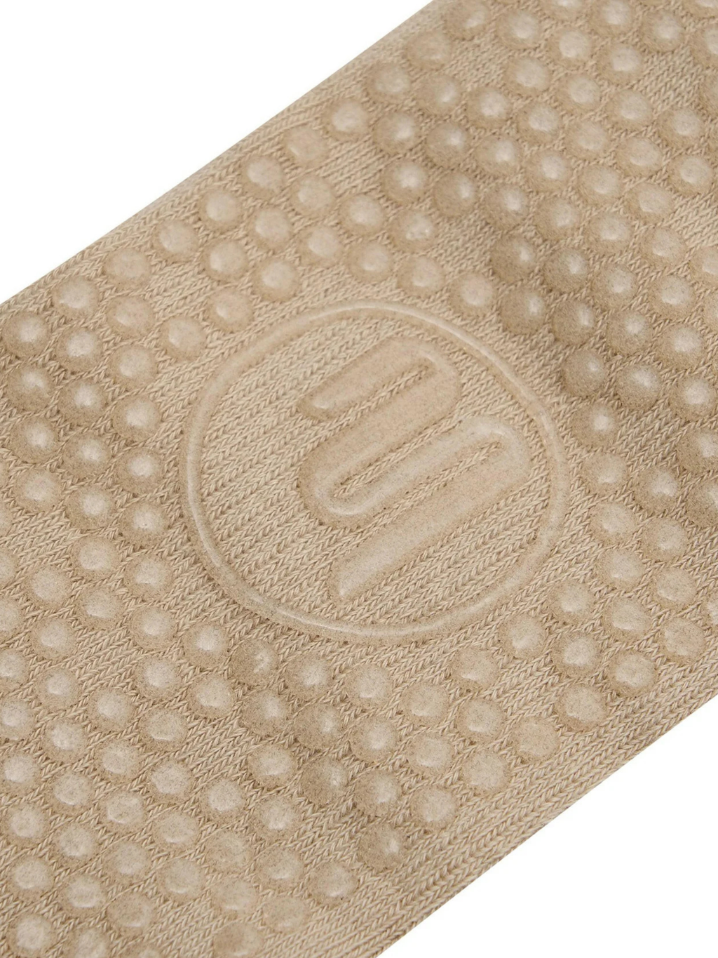 Beige textured mat with a logo in the center on a white background