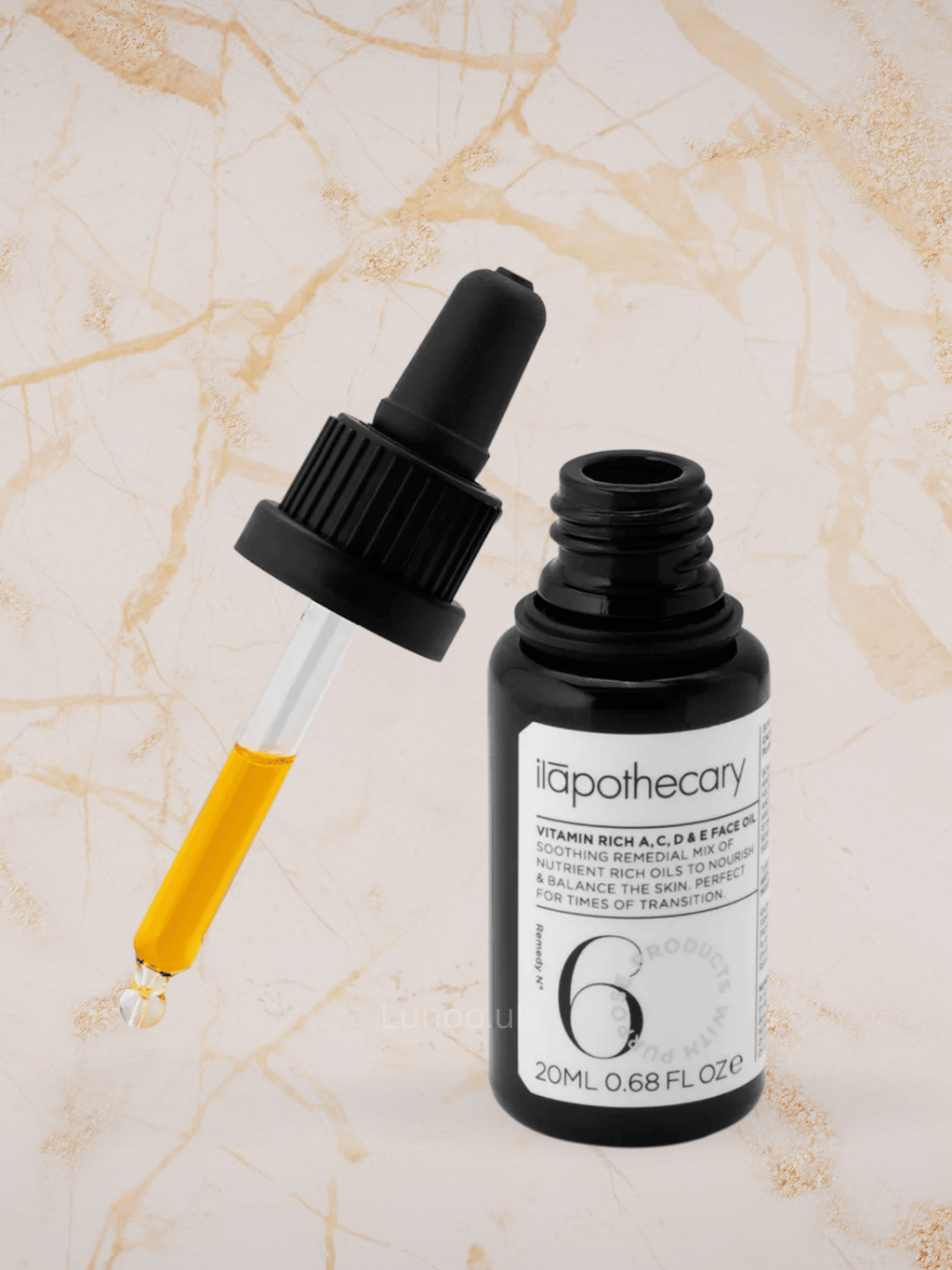 Black dropper bottle with a white label on a beige textured background