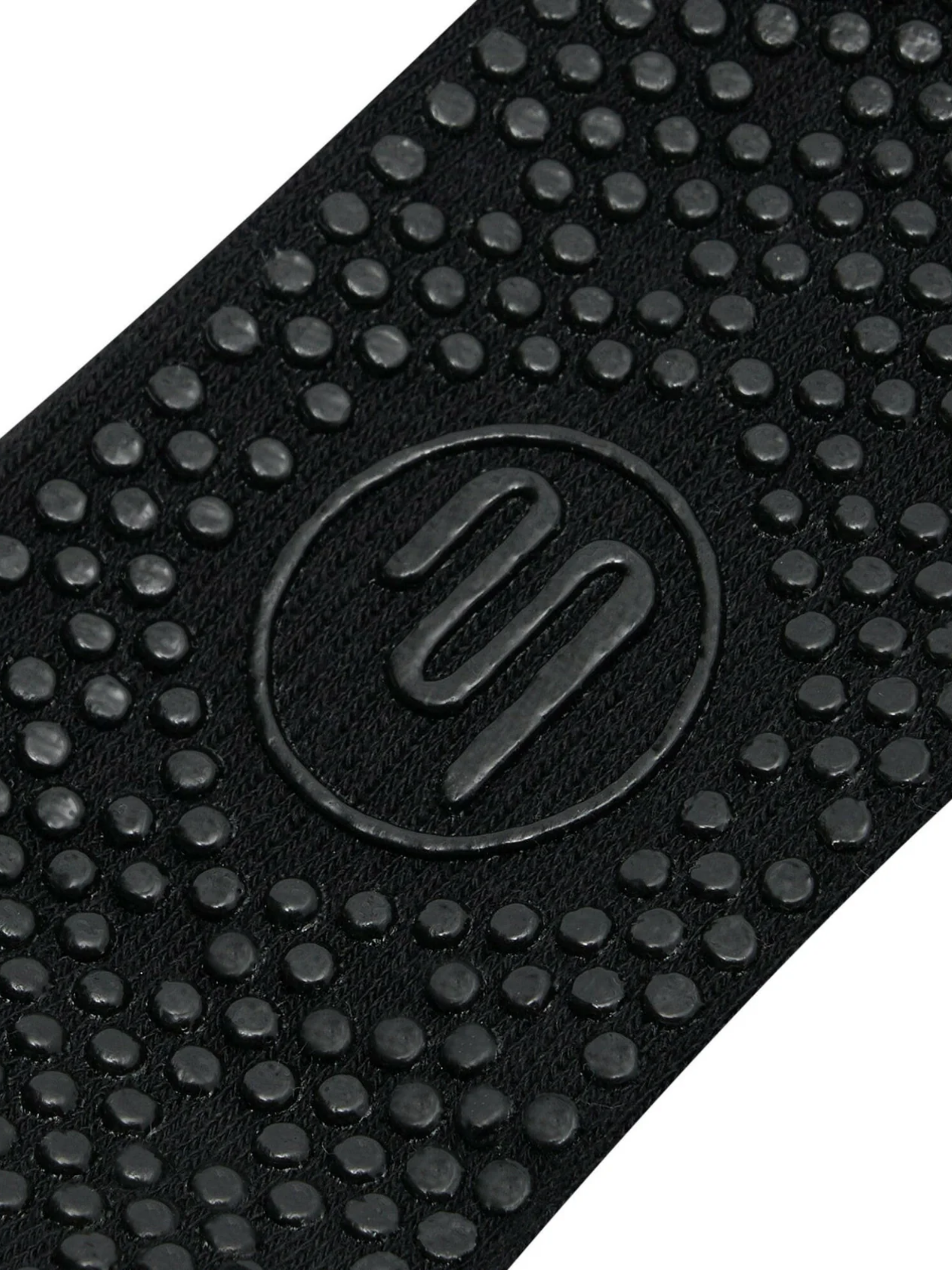 Close-up of a black textured mat with a logo in the center.