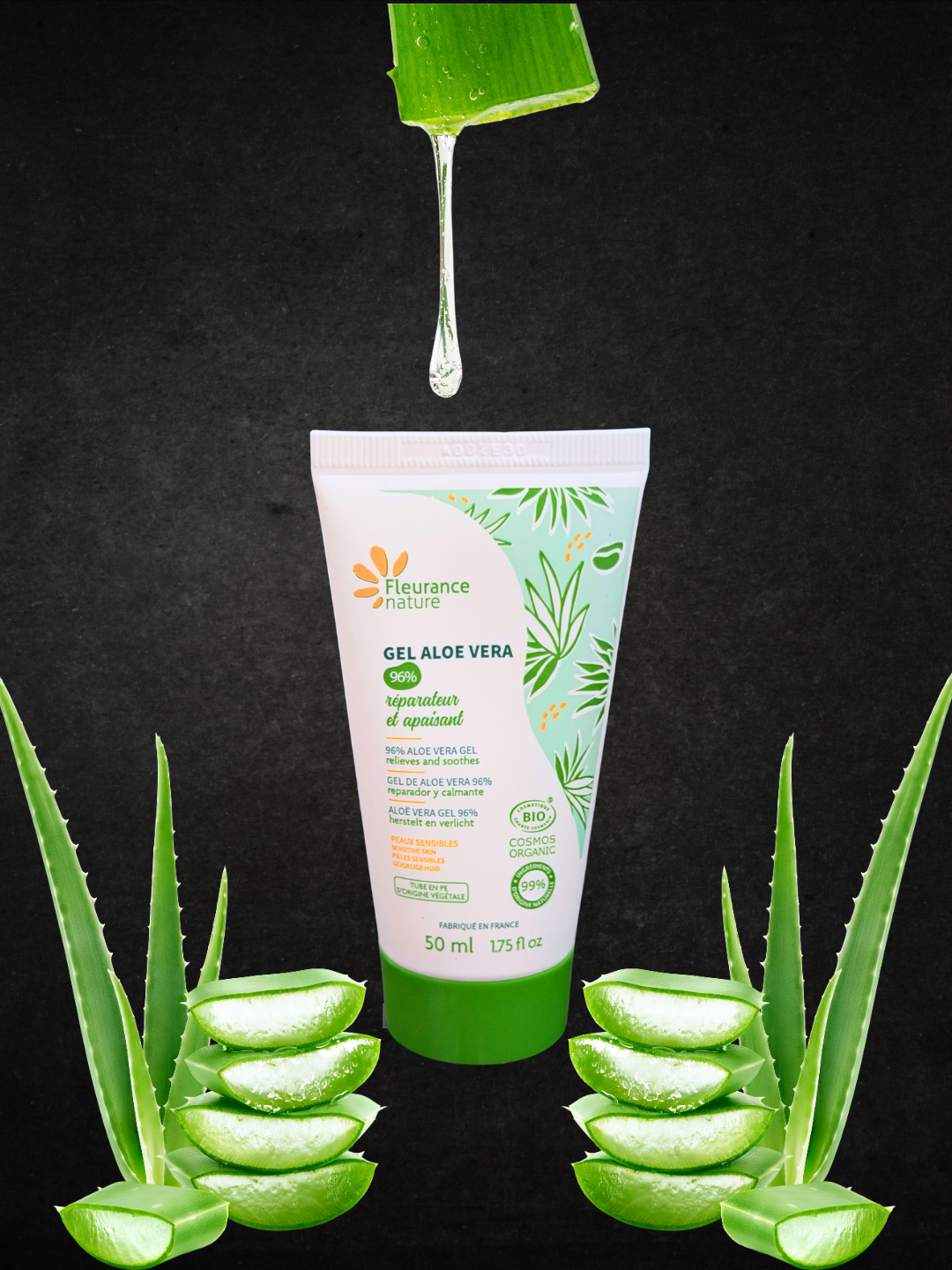 A 50 ml squeeze tube of Fleurance Nature Aloe Vera Gel centered on a black background, with aloe vera slices arranged around the base and a green aloe leaf dripping gel above the tube.