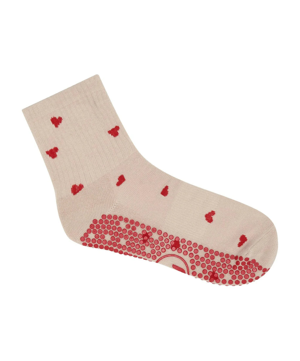Beige sock with red heart patterns on a white background