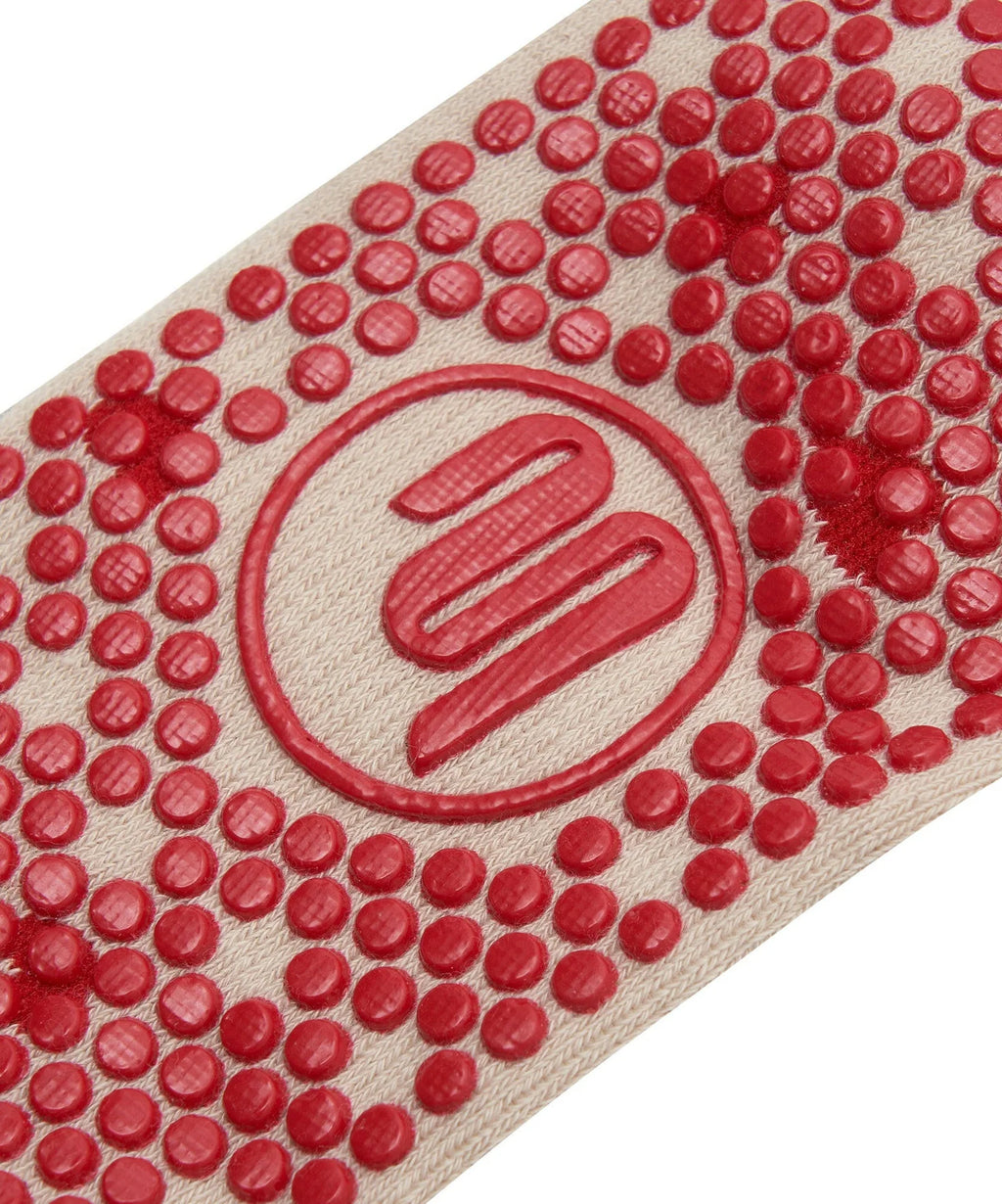 Close-up of a red textured mat with a logo in the center on a white background