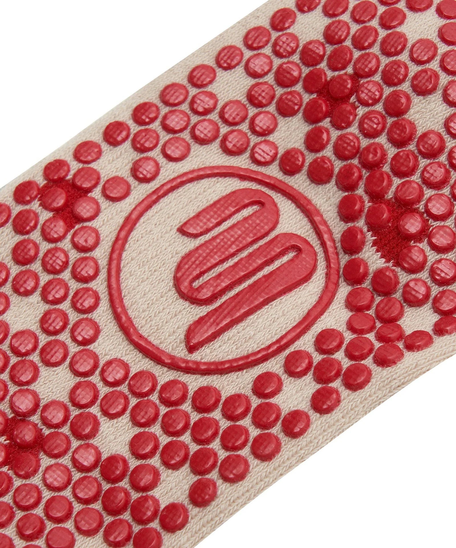 Close-up of a red textured mat with a logo in the center on a white background
